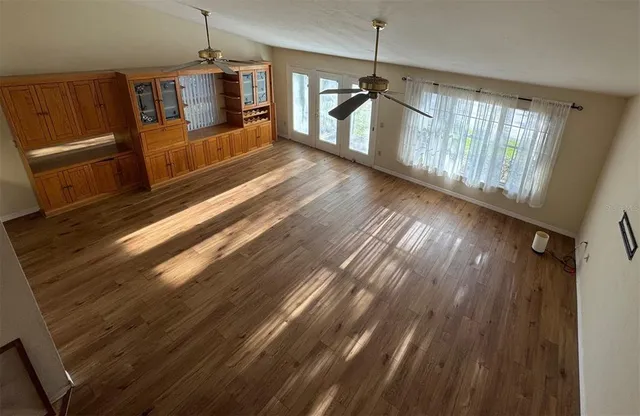 a open kitchen with wooden floor and a sink