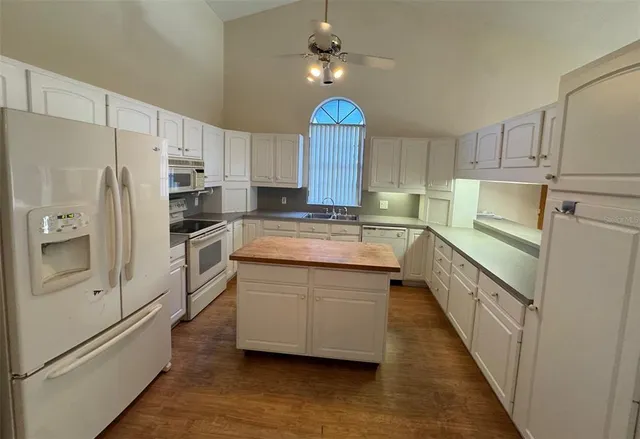 a kitchen with stainless steel appliances a refrigerator sink and microwave