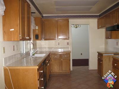 3201 Shale Road Palmdale, CA 93550 - Photo 5 of 7 a kitchen with a sink stove and cabinets