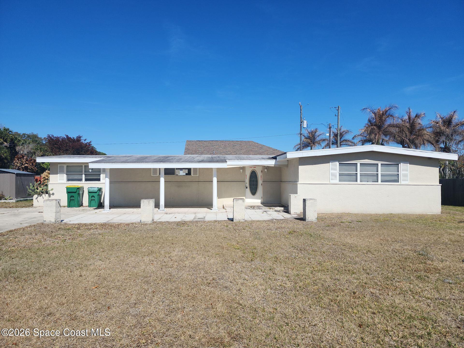 180 Church Road Merritt Island, FL 32953 - Photo 1 of 14 a front view of a house with a yard