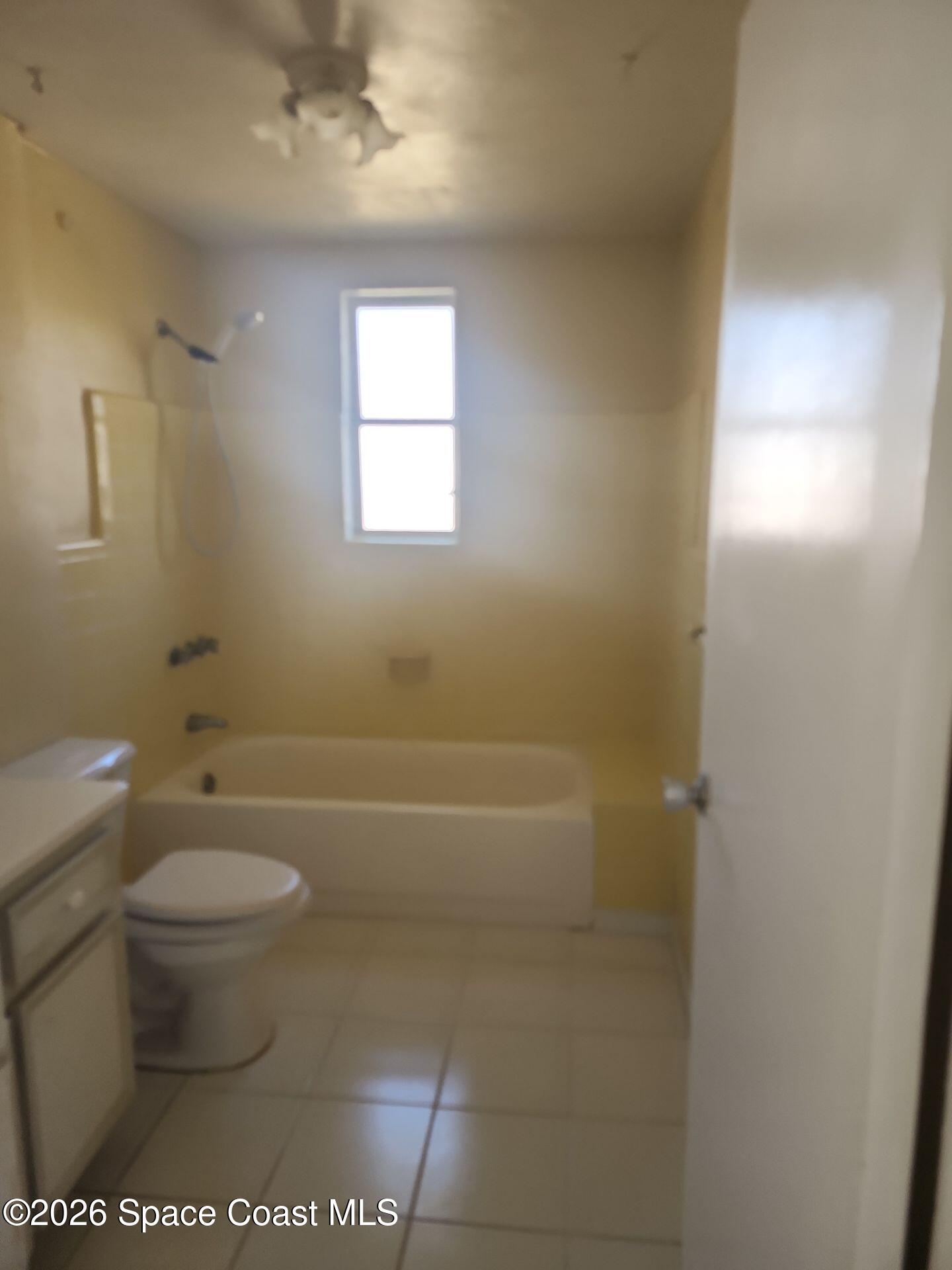 180 Church Road Merritt Island, FL 32953 - Photo 11 of 14 a bathroom with a toilet and a bathtub