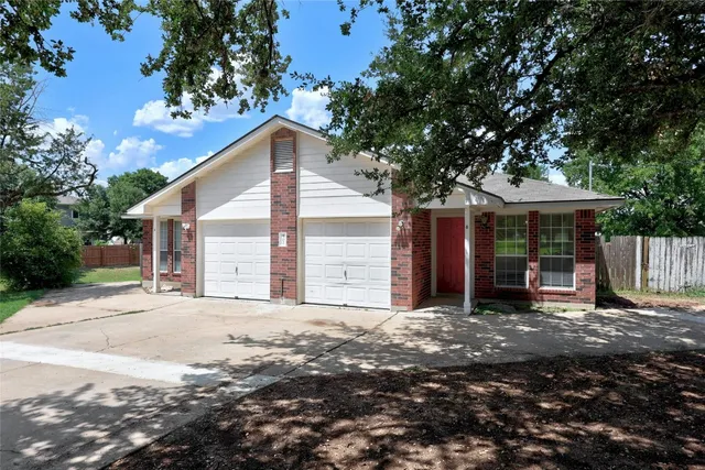 a view of a house with a yard and tree