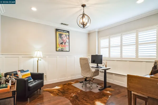a view of a livingroom with workspace and a window