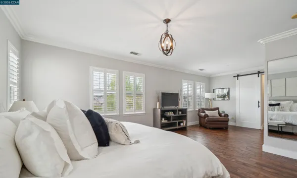 a bedroom with furniture and a window