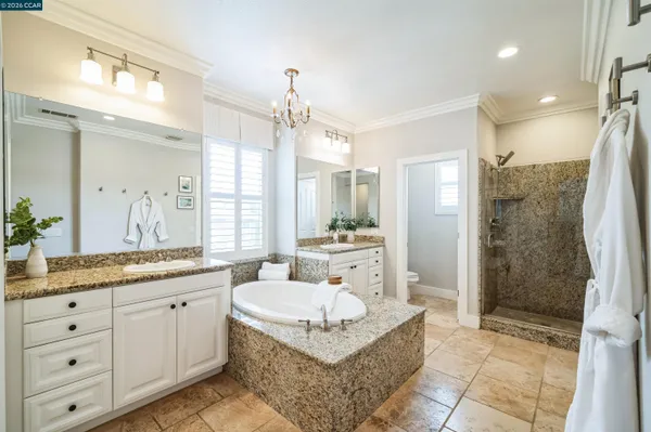 a spacious bathroom with a granite countertop sink mirror and shower