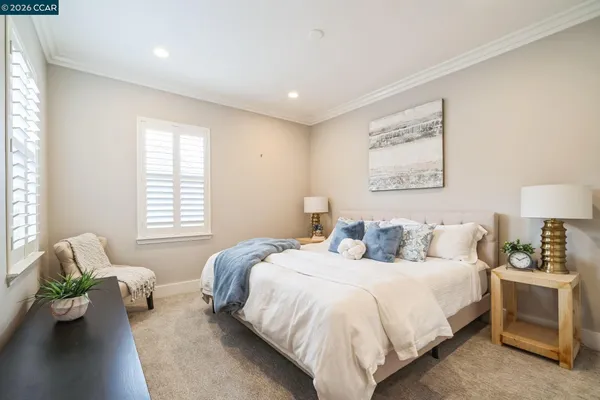 a spacious bedroom with a bed and couch