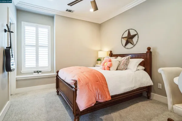 a spacious bedroom with a bed and a window