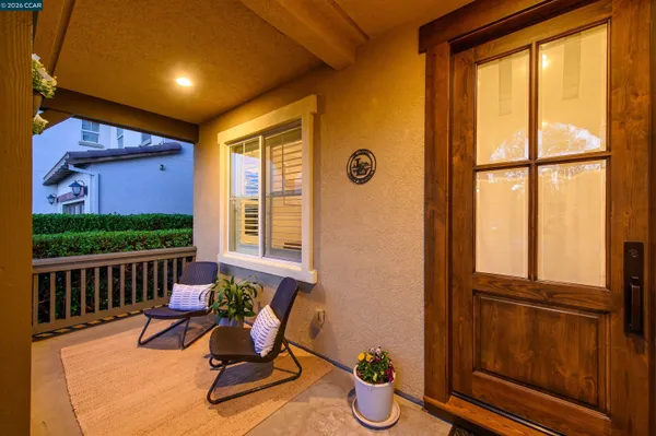 a view of a chairs and table in the balcony