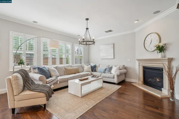 a living room with furniture a fireplace and a large window