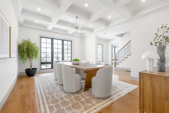 a living room with furniture a chandelier and a rug