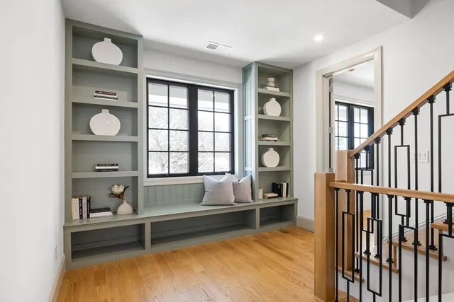 a living room with wooden floor and a window
