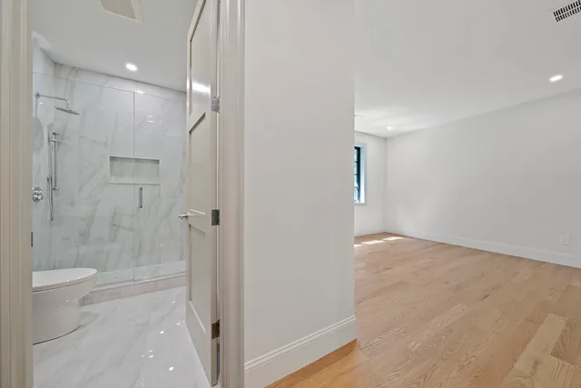 a bathroom with a shower and a glass door