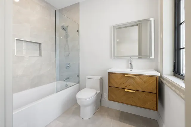 a bathroom with a toilet sink and shower