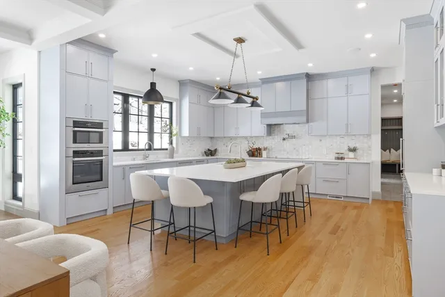 a large kitchen with a table and chairs