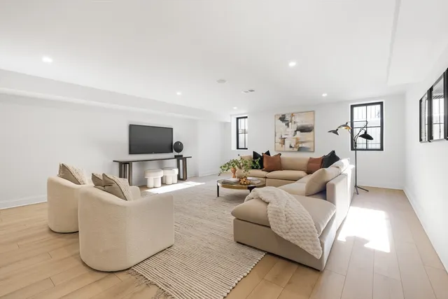 a living room with couches and a flat screen tv