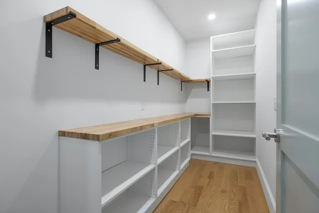 a view of walk in closet with empty racks