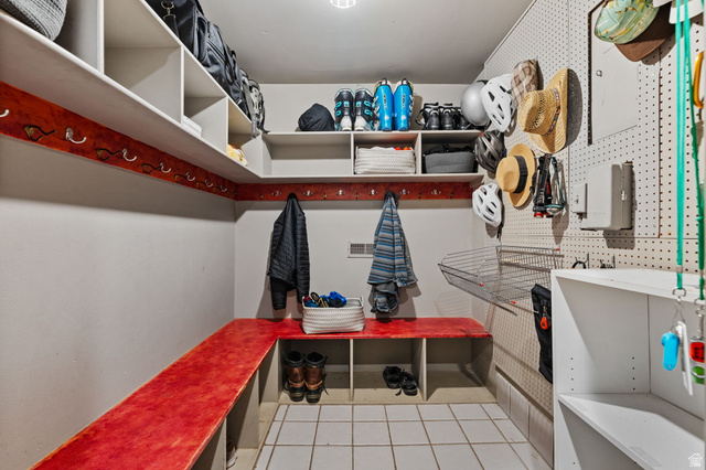 1856 Fort Canyon Road Alpine, UT 84004 - Photo 28 of 49 Dedicated storage room featuring multiple built-in shelving units, integrated bench seating, and an extensive pegboard wall