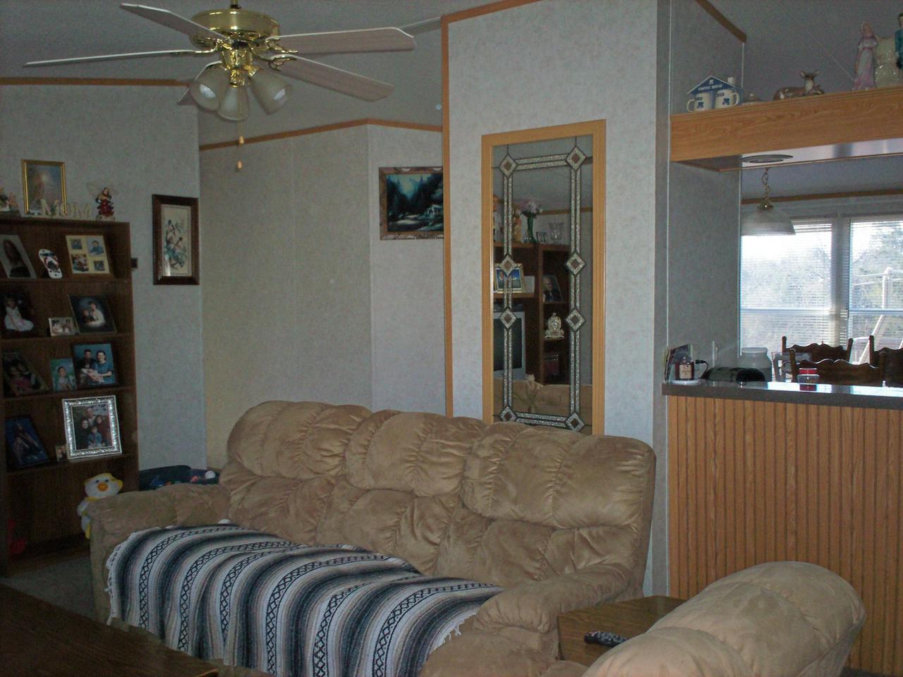 1775 Harmony School Road Hardy, VA 24101 - Photo 3 of 8 a bed sitting in a bedroom next to a window and a chandelier