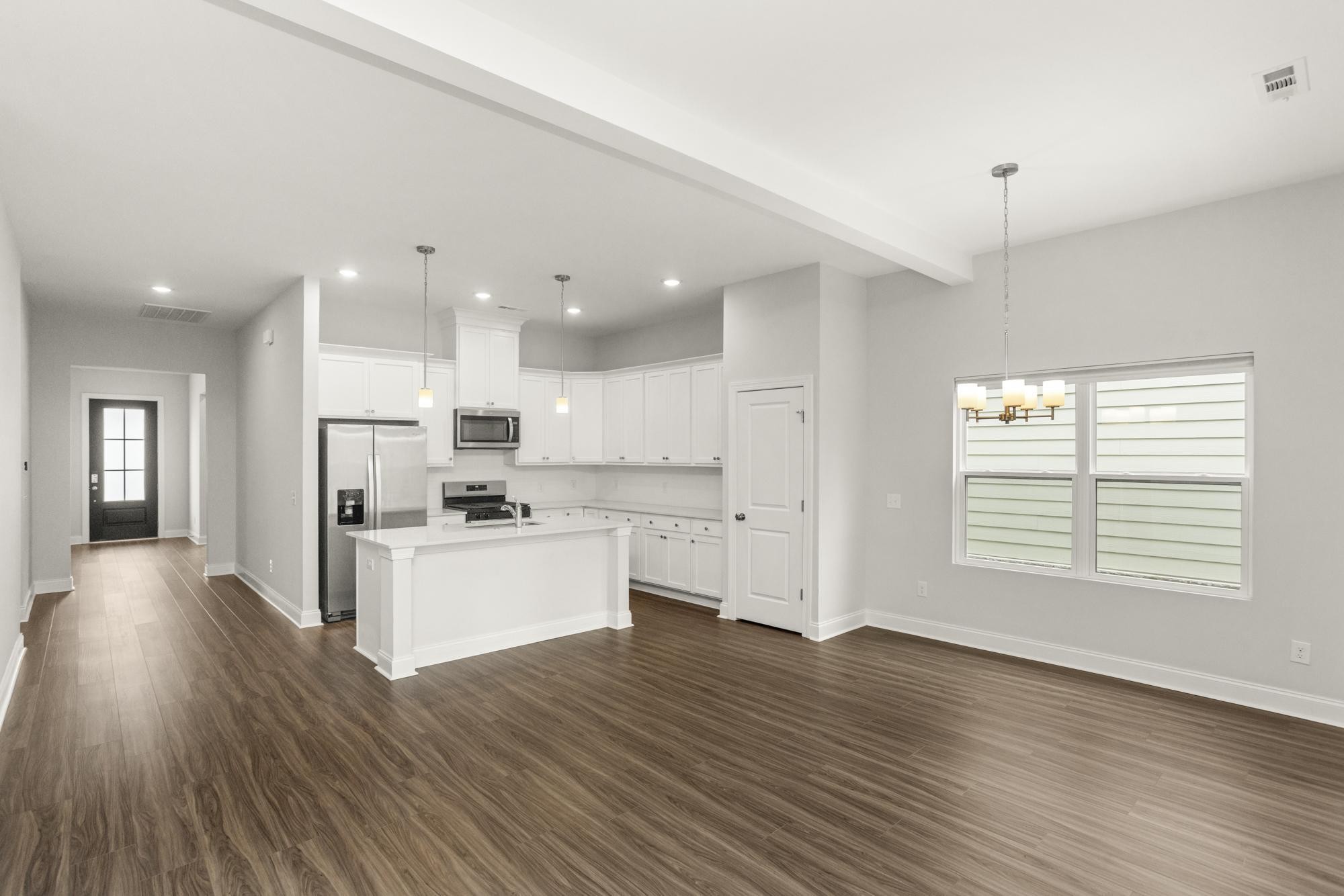 3706 Apies Street Murfreesboro, TN 37129 - Photo 13 of 42 a kitchen with stainless steel appliances kitchen island wooden floors and white cabinets