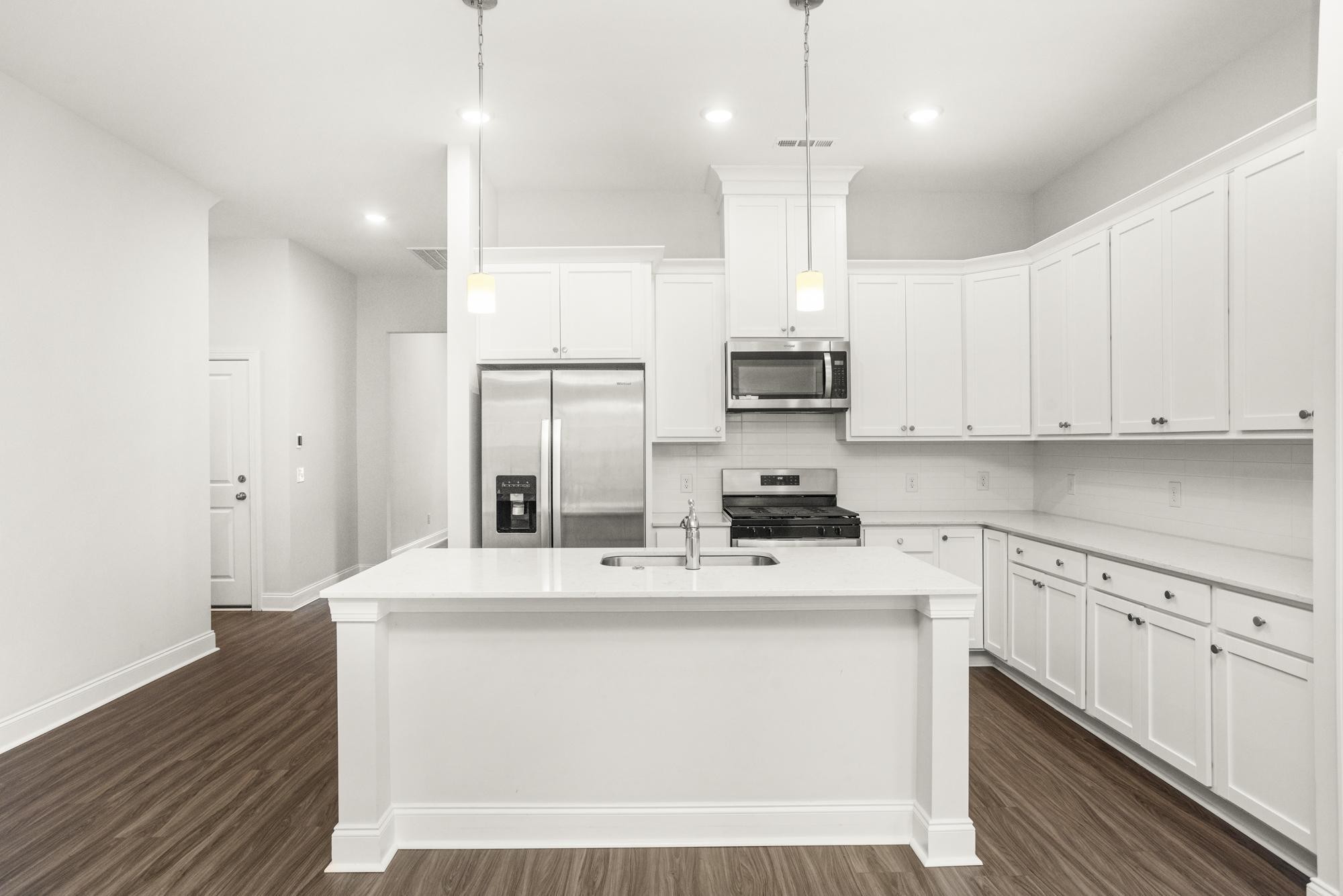 3706 Apies Street Murfreesboro, TN 37129 - Photo 7 of 42 a kitchen with kitchen island a sink stainless steel appliances and white cabinets