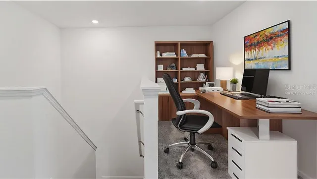 a view of a workspace with furniture and a gate
