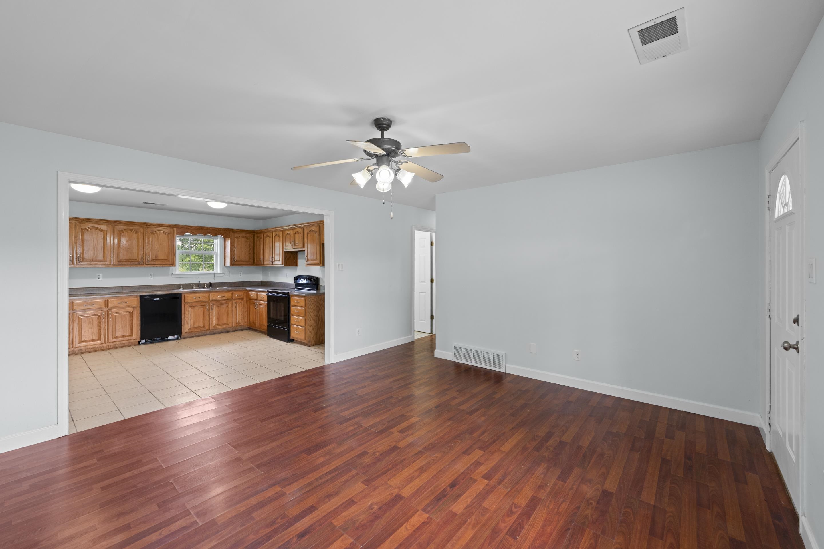 1038 Jamestown Road Burlison, TN 38015 - Photo 6 of 24 Kitchen with light wood finished floors, visible vents, and black appliances