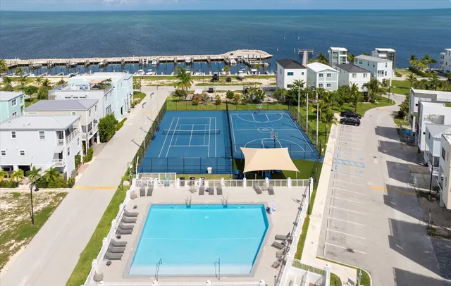 a view of pool with outdoor seating and city view