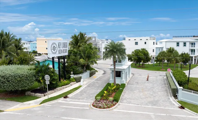 a view of a patio with table and chairs potted plants with floor to ceiling window