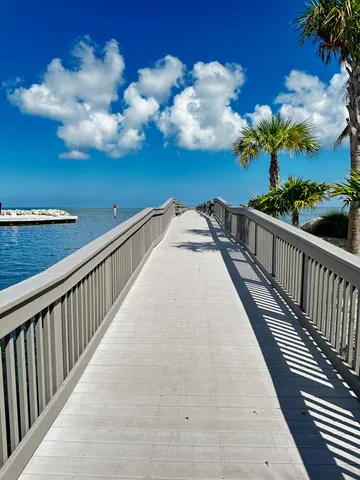 a view of a house with pool and chairs