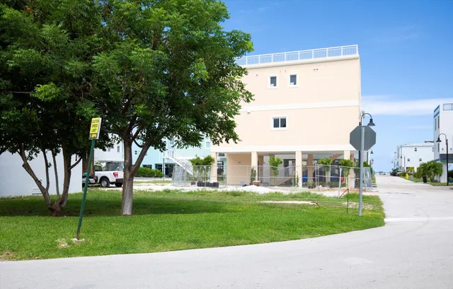 a front view of multiple houses with yard