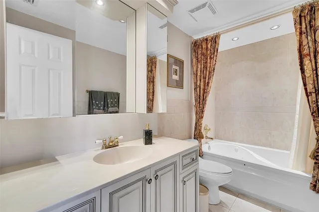 a bedroom with a bed window and a flat screen tv