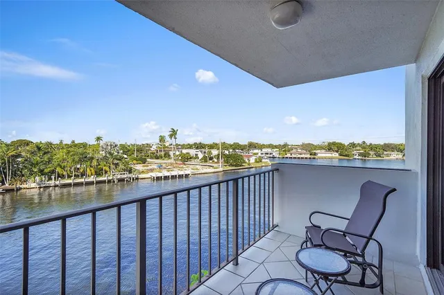 a balcony with table and chairs