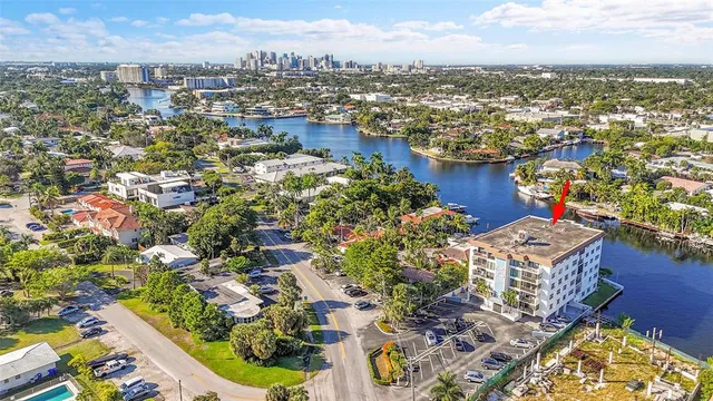 a view of a lake with a bench and trees in the background