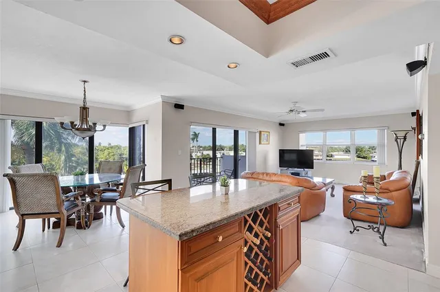 a kitchen with stainless steel appliances kitchen island granite countertop a sink and cabinets