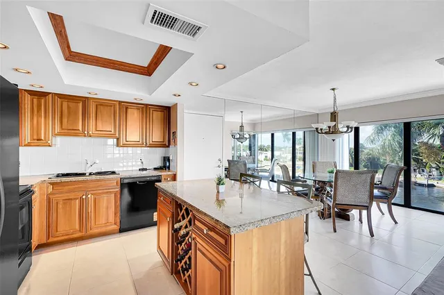 a kitchen with stainless steel appliances granite countertop a refrigerator and a stove top oven