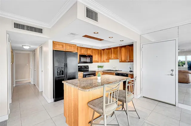 a living room with fireplace furniture and a large window