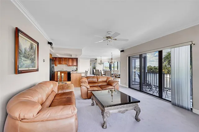 a living room with furniture gym equipment and a large window