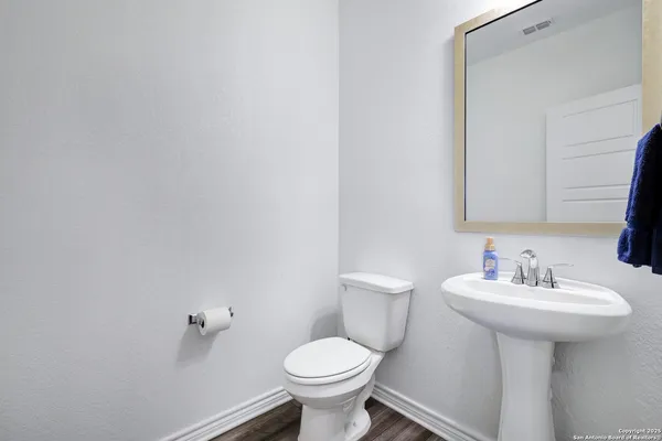 a bathroom with a sink toilet and a mirror