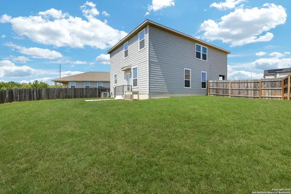 a view of a house with a yard and sitting area