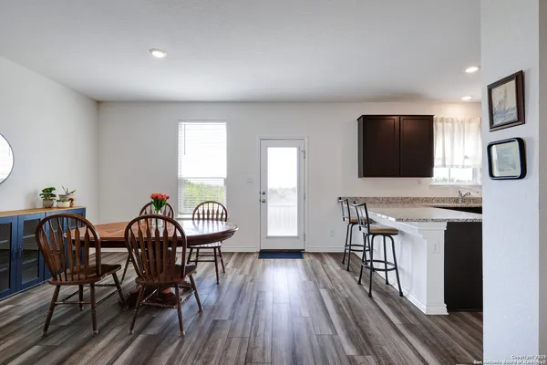 a view of a dining room with furniture and wooden floor
