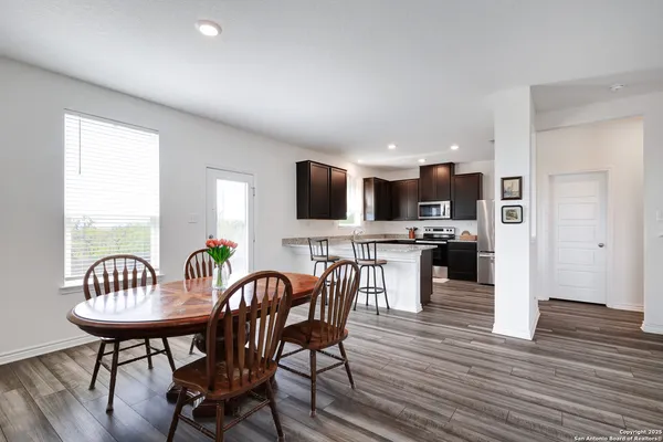 a view of kitchen with dining table and chairs