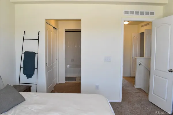 a bedroom with a bed and a mirror