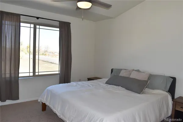 a bedroom with a bed and window