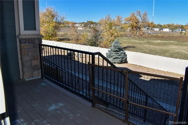 a view of a balcony with chair and wooden floor