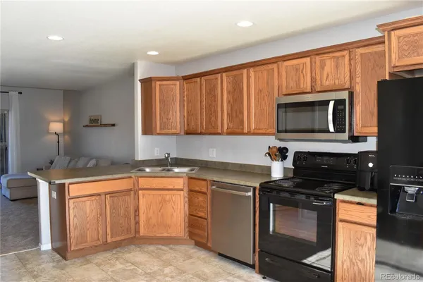 a kitchen with a sink stove and microwave