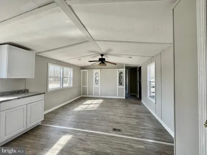 a view of a kitchen with a sink and cabinets
