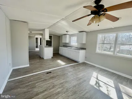 a kitchen with stainless steel appliances a stove refrigerator and cabinets