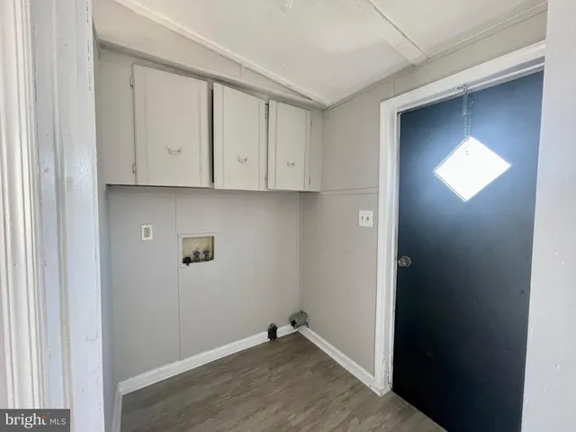 a view of an empty room with closet and a window