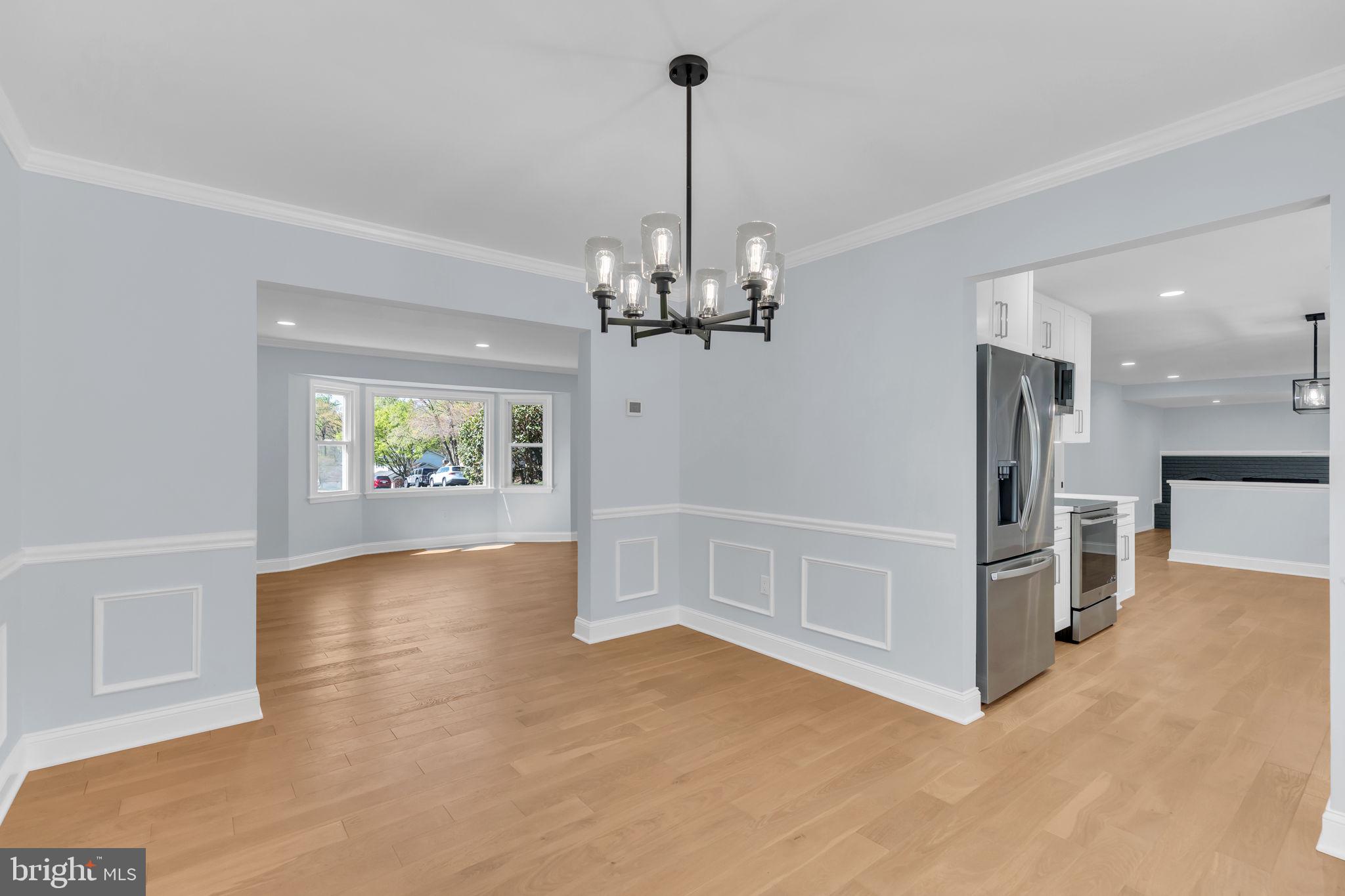 7804 Carrleigh Parkway Springfield, VA 22152 - Photo 13 of 61 a view of a livingroom with a furniture wooden floor kitchen and a chandelier