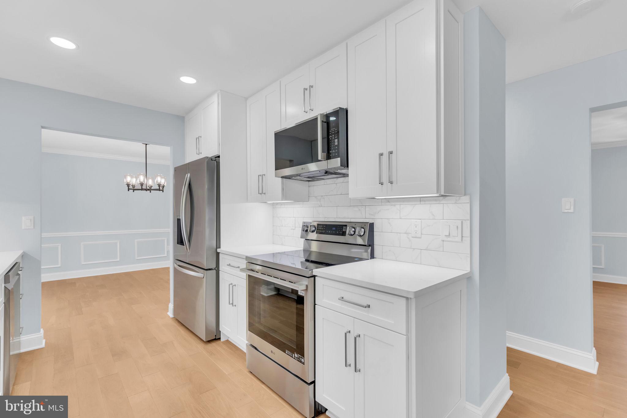 7804 Carrleigh Parkway Springfield, VA 22152 - Photo 17 of 61 a kitchen with stainless steel appliances a refrigerator stove and microwave